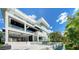 Striking modern home boasts clean lines, outdoor living space with pool, and lush tropical landscaping at 1610 N Lodge Dr, Sarasota, FL 34239