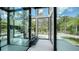 Bright modern foyer with a glass staircase and large windows offering scenic views at 1610 N Lodge Dr, Sarasota, FL 34239