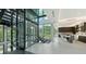 Hallway featuring a glass elevator, stairs and modern interior design with lots of light near kitchen and dining area at 1610 N Lodge Dr, Sarasota, FL 34239