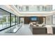 Expansive living room featuring a glass floor, a modern fireplace, and sliding glass doors to the outdoors at 1610 N Lodge Dr, Sarasota, FL 34239