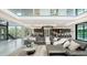 Spacious living room with contemporary decor, floor-to-ceiling windows, and abundant natural light at 1610 N Lodge Dr, Sarasota, FL 34239