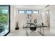 Bright home office with a modern desk, sleek decor, and natural light from the three windows at 1610 N Lodge Dr, Sarasota, FL 34239