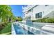 Stunning modern home boasts a long pool and tropical landscaping, perfect for outdoor relaxation and entertainment at 1610 N Lodge Dr, Sarasota, FL 34239