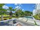 Lush backyard with an inviting pool, fire pit area, and vibrant landscaping, perfect for outdoor enjoyment and relaxation at 1610 N Lodge Dr, Sarasota, FL 34239