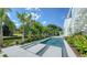 Inviting pool with elegant landscaping, set against a backdrop of lush greenery and a modern home design at 1610 N Lodge Dr, Sarasota, FL 34239