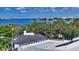 Enjoy panoramic water views from this rooftop terrace, overlooking the bridge and cityscape beyond lush greenery at 1610 N Lodge Dr, Sarasota, FL 34239