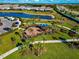 Aerial view of a playground and lake in a residential community, close to sidewalks and a parking lot at 16231 Tradewind Ter, Bradenton, FL 34211
