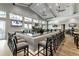 Upscale bar area featuring a sleek counter, modern barstools, and multiple televisions for entertainment at 16231 Tradewind Ter, Bradenton, FL 34211