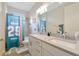 This home features a bathroom with double sinks and shower with sporty decor at 16231 Tradewind Ter, Bradenton, FL 34211