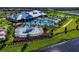Panoramic aerial shot of the community center featuring a splash pad, pool, and lush landscaping at 16231 Tradewind Ter, Bradenton, FL 34211