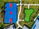 Aerial view of a colorful basketball court and putting green area with nearby walking paths at 16231 Tradewind Ter, Bradenton, FL 34211