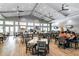 Spacious dining area with multiple tables and chairs, complemented by large windows and a light, airy ambiance at 16231 Tradewind Ter, Bradenton, FL 34211