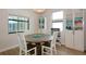 Cozy dining area features a round wooden table and modern decor, perfect for Gathering meals at 16231 Tradewind Ter, Bradenton, FL 34211
