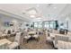 A well-lit dining room with square tables, striped chairs, and multiple TV screens at 16231 Tradewind Ter, Bradenton, FL 34211