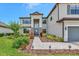 Elegant two-story home with stone accents, lush landscaping, and a welcoming entrance at 16231 Tradewind Ter, Bradenton, FL 34211