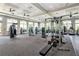 Modern fitness center equipped with various weight machines and cardio equipment, enhanced by bright, natural lighting at 16231 Tradewind Ter, Bradenton, FL 34211
