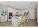 Bright kitchen with stainless steel appliances, white cabinets, and spacious quartz island with seating at 16231 Tradewind Ter, Bradenton, FL 34211