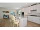 Modern kitchen with white cabinets, island seating, and stainless steel appliances at 16231 Tradewind Ter, Bradenton, FL 34211