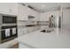 Modern kitchen featuring sleek stainless appliances, an undermount sink and stylish tiled backsplash at 16231 Tradewind Ter, Bradenton, FL 34211