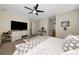 This main bedroom features a ceiling fan, neutral paint and en suite bathroom at 16231 Tradewind Ter, Bradenton, FL 34211