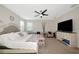 This spacious main bedroom features lots of natural light and a ceiling fan at 16231 Tradewind Ter, Bradenton, FL 34211