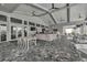 Outdoor bar area with TV, bar seating, tables, and views of lush landscaping at 16231 Tradewind Ter, Bradenton, FL 34211