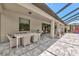 This patio includes a dining table, space heaters, and view of the partially enclosed backyard at 16231 Tradewind Ter, Bradenton, FL 34211