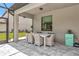A covered patio with dining table set and view of green lawn at 16231 Tradewind Ter, Bradenton, FL 34211