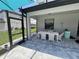 Charming screened patio with a dining table, perfect for outdoor meals and entertaining at 16231 Tradewind Ter, Bradenton, FL 34211