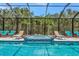 Stunning screened-in pool area with a spa and ample seating for relaxing at 16231 Tradewind Ter, Bradenton, FL 34211
