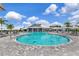 Beautiful community pool with lounge chairs and umbrellas, perfect for relaxing and enjoying the sunny weather at 16231 Tradewind Ter, Bradenton, FL 34211