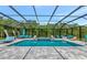 A gorgeous screened pool area with an in-ground spa and plenty of lounge seating at 16231 Tradewind Ter, Bradenton, FL 34211