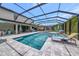 A screened pool with an in-ground spa sits in a backyard oasis at 16231 Tradewind Ter, Bradenton, FL 34211