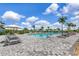 Beautiful swimming pool with plenty of lounge chairs and umbrellas at 16231 Tradewind Ter, Bradenton, FL 34211