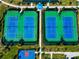 Aerial image featuring four tennis courts inside of a fenced in area with sidewalks at 16231 Tradewind Ter, Bradenton, FL 34211