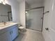 Bathroom featuring gray sink and a shower with glass door at 17134 Savory Mist Cir, Bradenton, FL 34211