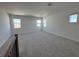 Large bonus room on upper floor featuring plush carpeting and three windows at 17134 Savory Mist Cir, Bradenton, FL 34211