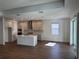 Spacious kitchen featuring an island with a marble countertop, stainless steel appliances, and gray cabinets, offering ample room at 17134 Savory Mist Cir, Bradenton, FL 34211
