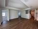Open-concept living room with wood flooring, providing a blank canvas for customization and a bright, inviting atmosphere at 17134 Savory Mist Cir, Bradenton, FL 34211