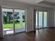 Living room with beautiful wood floors and sliding glass doors leading to the outdoor patio, creating an airy and inviting space at 17134 Savory Mist Cir, Bradenton, FL 34211