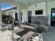 Comfortable outdoor seating area with stone fireplace and TV at 17134 Savory Mist Cir, Bradenton, FL 34211