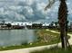 Waterfront homes overlooking a picturesque pond with a fountain and sidewalks, with lush landscaping and community space at 17134 Savory Mist Cir, Bradenton, FL 34211