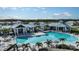 An aerial view showcases a luxurious community pool with plenty of seating and tropical landscaping at 17134 Savory Mist Cir, Bradenton, FL 34211