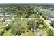 An aerial view of a neighborhood highlighting its well-spaced homes, green lawns, and mature trees at 2026 Arkansas Ave, Englewood, FL 34224