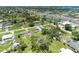 The aerial perspective displays a residential area with lush greenery and properties, including a swimming pool at 2026 Arkansas Ave, Englewood, FL 34224