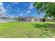 Exterior view of the house, showcasing a large fenced backyard, screened in patio, and shed at 2026 Arkansas Ave, Englewood, FL 34224