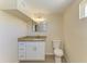 This bathroom features a granite countertop, white cabinets, and a modern rectangular mirror at 2026 Arkansas Ave, Englewood, FL 34224