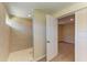 Modern bathroom with tiled walk-in shower featuring a glass door and a view into the attached bedroom at 2026 Arkansas Ave, Englewood, FL 34224