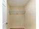 This walk-in closet features wire shelving for storage and a door leading into an attached room at 2026 Arkansas Ave, Englewood, FL 34224