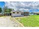 Quaint single-Gathering home features a screened-in porch and well-kept lawn at 2026 Arkansas Ave, Englewood, FL 34224